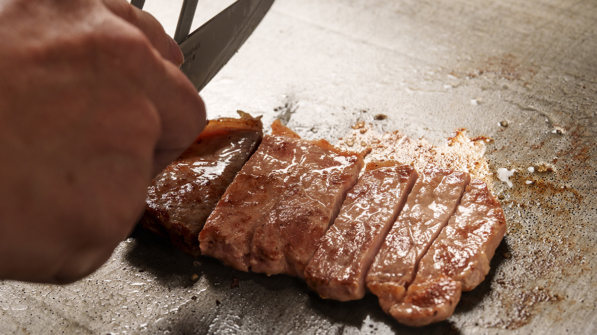 Slicing beef sirloin steak