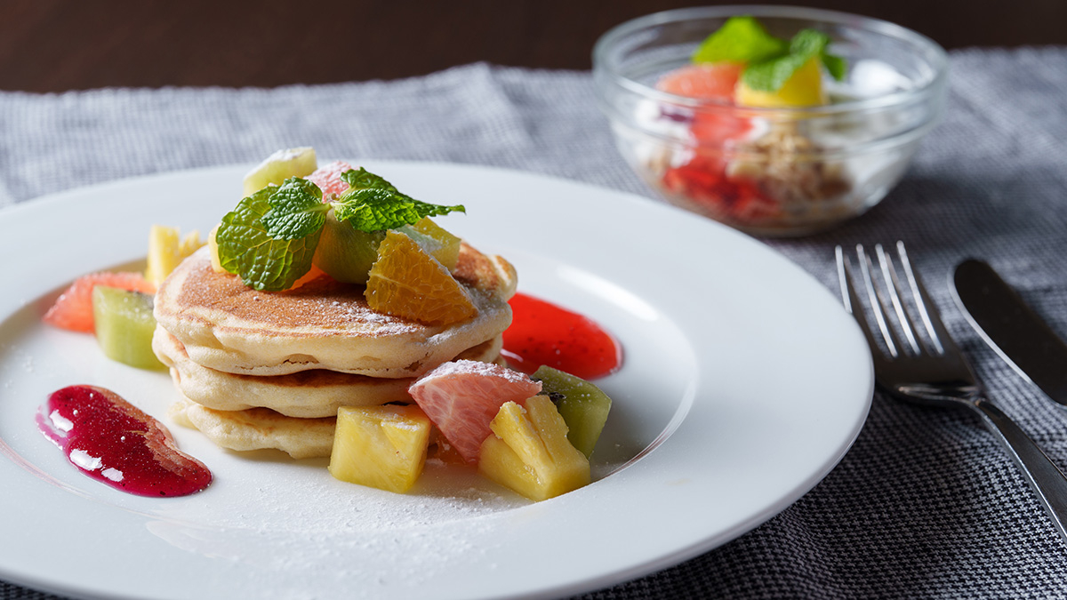 Pancakes Presented in a Dessert Style with Fruits and Powdered Sugar