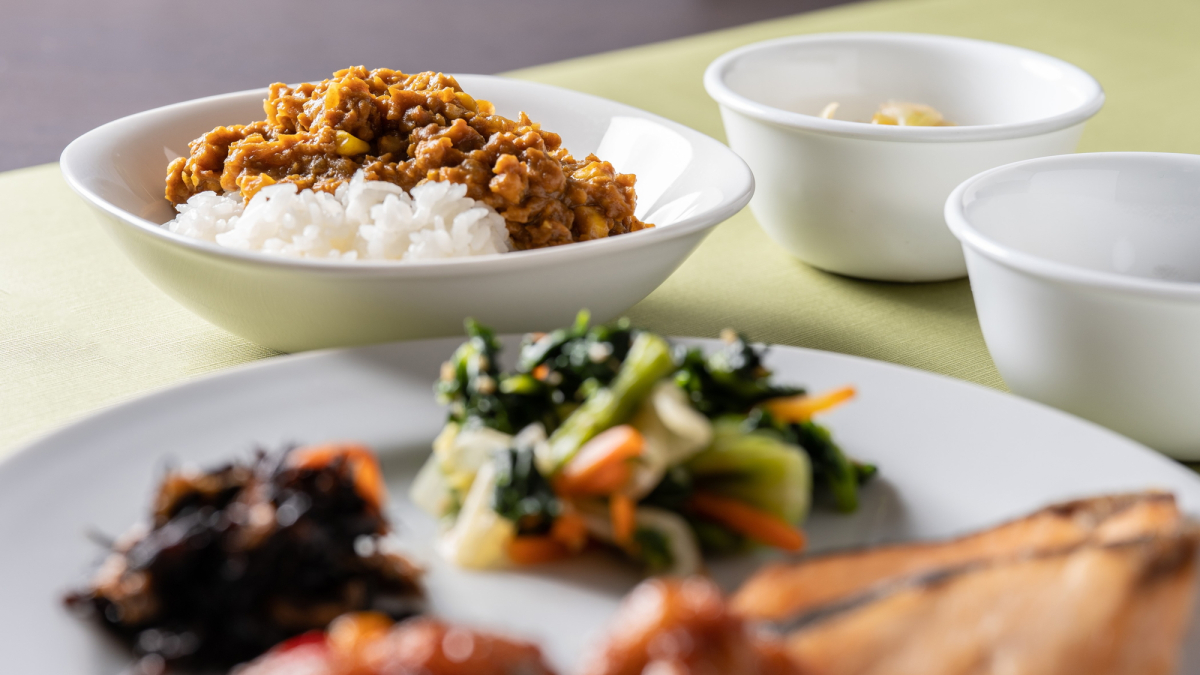 Close-up photo of soybean meat keema curry and side dishes on a plate.