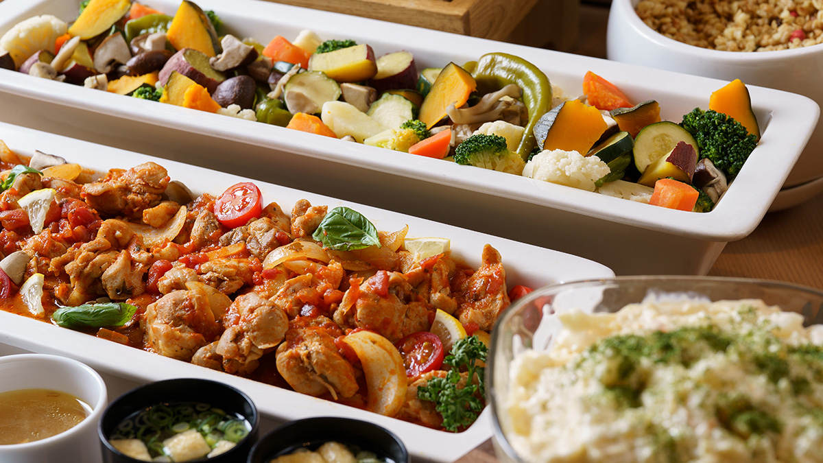 Chicken stewed in tomato sauce, steamed vegetables, and potato salad