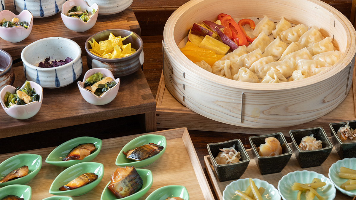A buffet featuring warm vegetable dishes and other selections