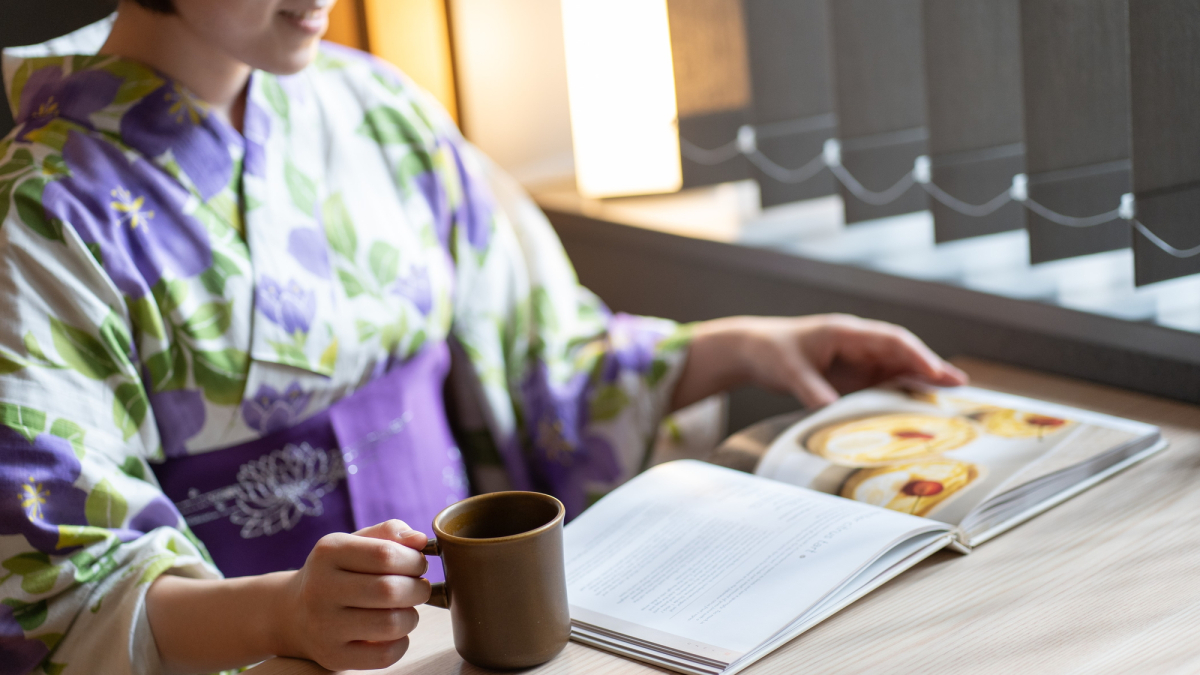 A woman in a yukata relaxing in the Vista Lounge