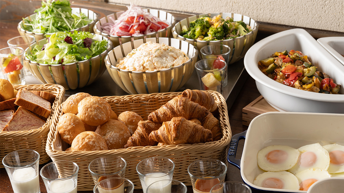 A buffet featuring a salad bar and a variety of breads
