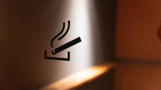 Inside view through a glass door with a pictogram of a smoking booth