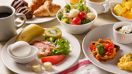 Continental plate with fruits, eggs, and buffet dishes