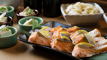 Assortment of side dishes including grilled salmon