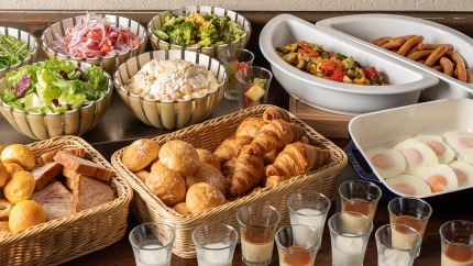 A buffet featuring a salad bar and a variety of breads