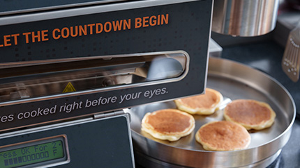 A Display of the Pancake Machine and Freshly Made Pancakes